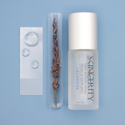 A bottle of Skincerity next to a sprig of lavender in a test tube and a microscope slide with drops of Lavandox, an advanced ingredient derived from lavender